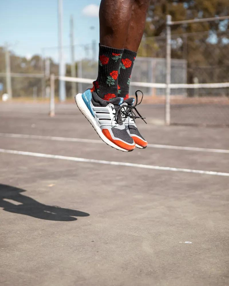 Runner’s shoes mid-stride on an athletics track